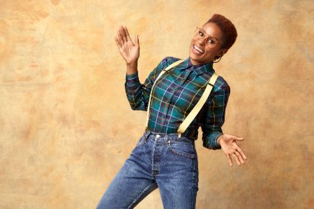 Issa Rae in a green shirt poses a picture.